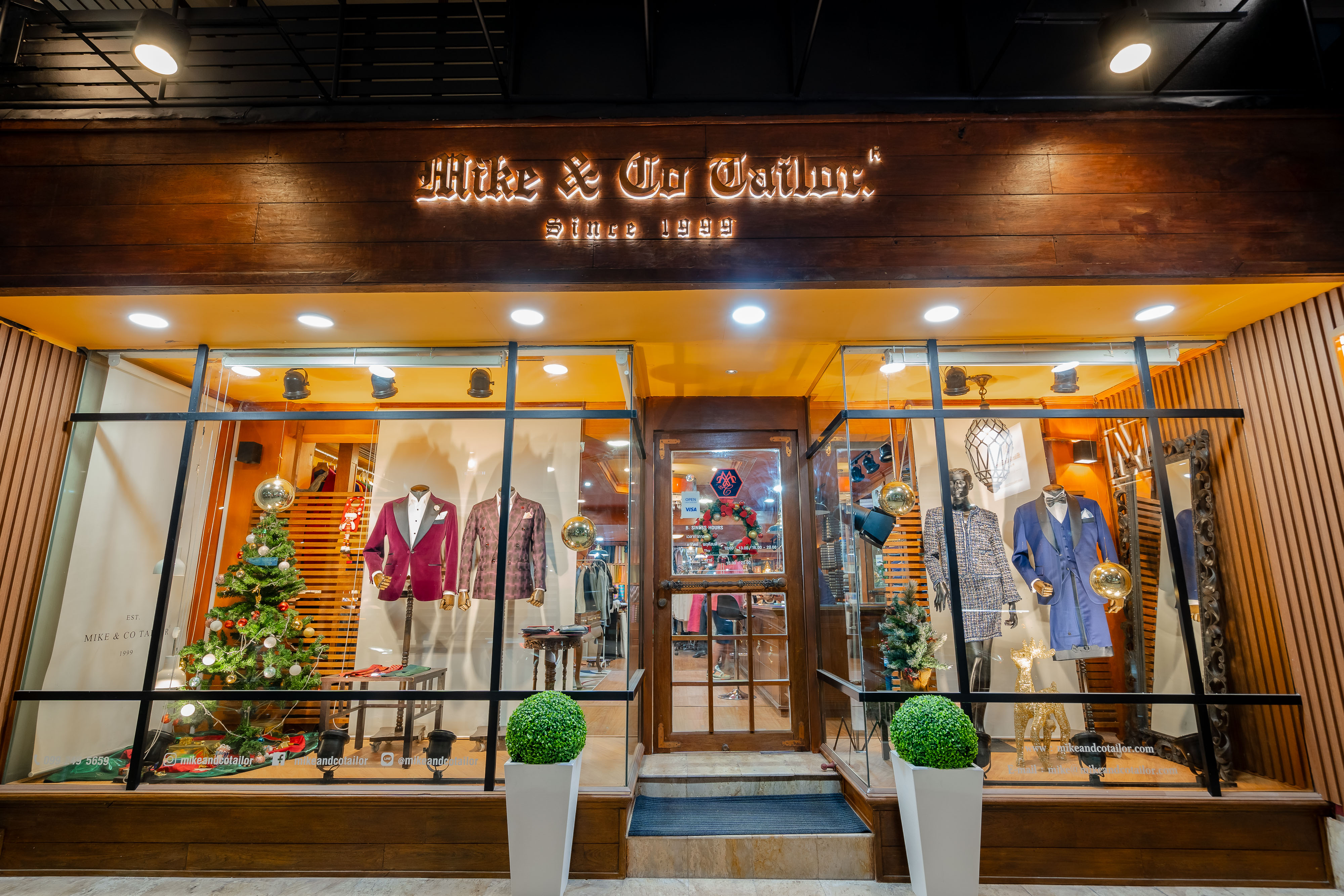 Mike & Co Tailor storefront at night